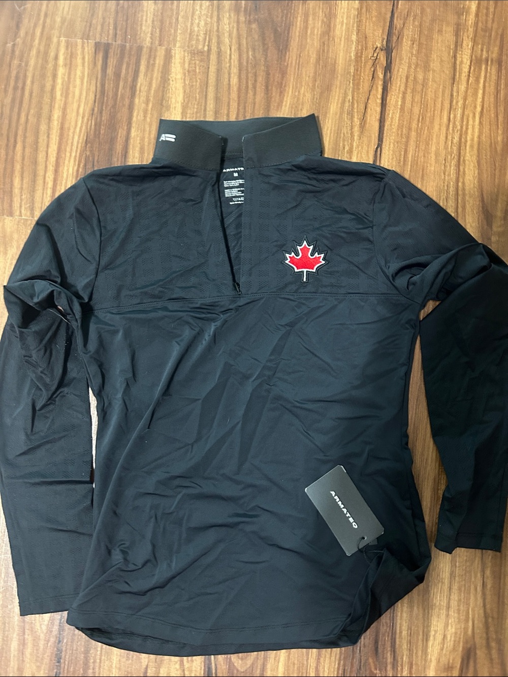 Black Long-Sleeve Men’s Performance Shirt with Red Maple Emblem
